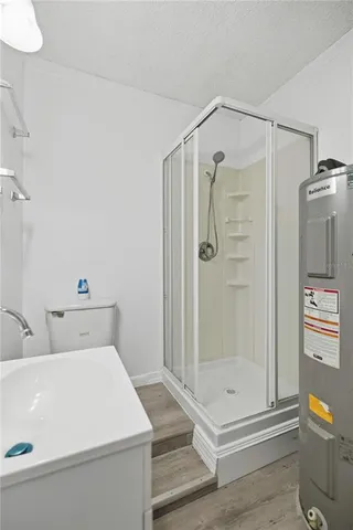 a bathroom with a shower and mirror