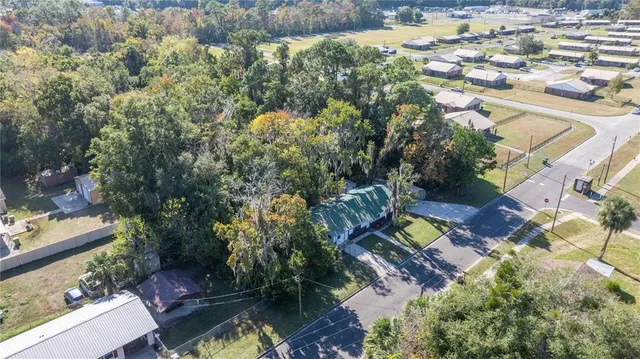an aerial view of residential house with outdoor space and swimming pool