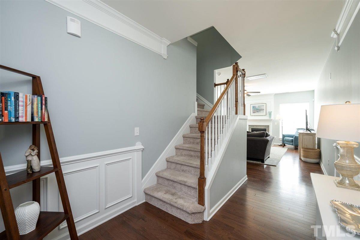 8705 Wild Magnolia Drive Raleigh, NC 27617 - Photo 2 of 15 a view of a hallway with wooden floor and staircase