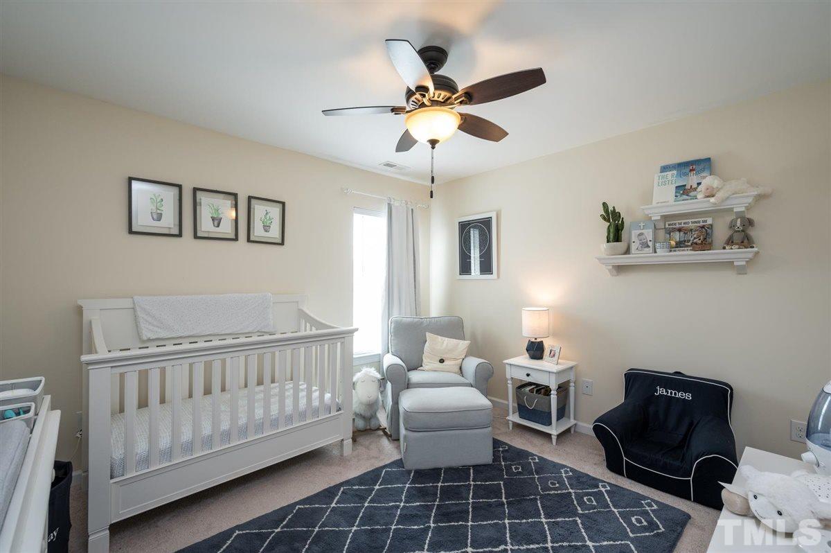 8705 Wild Magnolia Drive Raleigh, NC 27617 - Photo 11 of 15 a bedroom with furniture and a window
