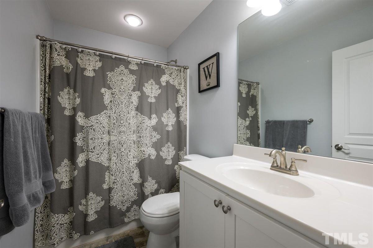 8705 Wild Magnolia Drive Raleigh, NC 27617 - Photo 12 of 15 a bathroom with a granite countertop sink toilet and shower