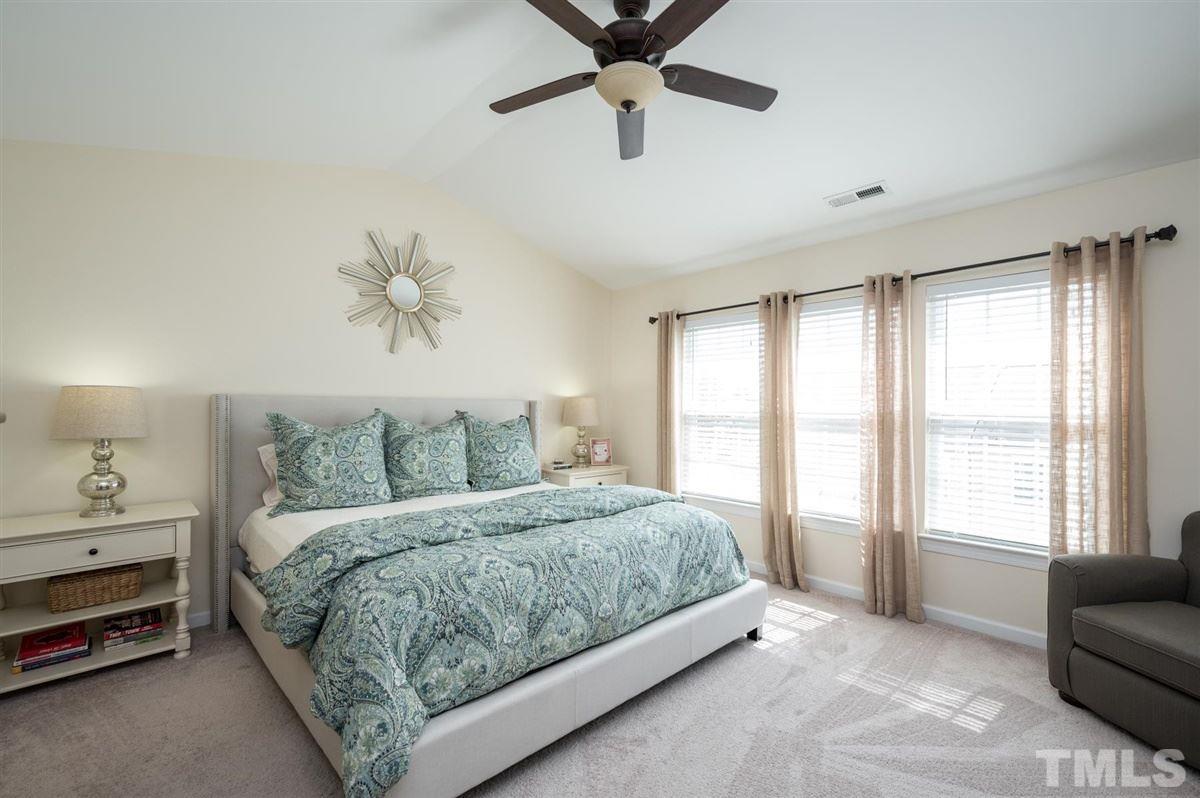 8705 Wild Magnolia Drive Raleigh, NC 27617 - Photo 13 of 15 a bedroom with a bed couch and window