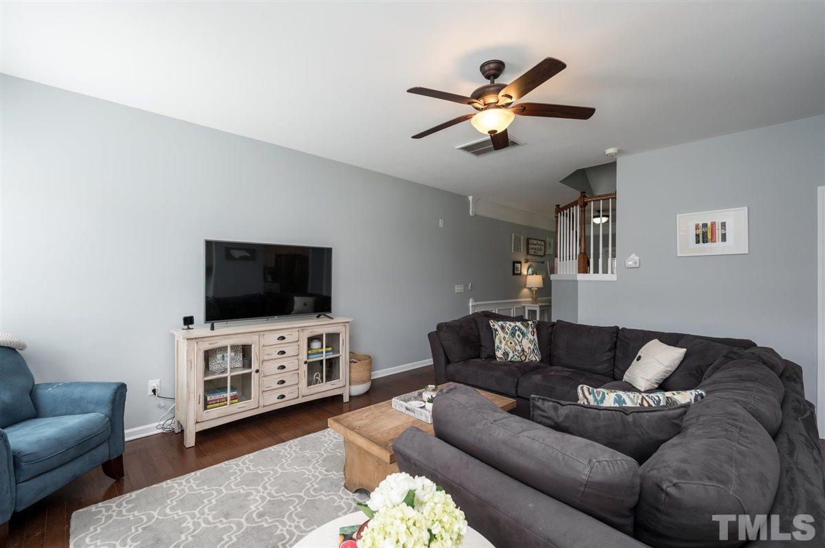 8705 Wild Magnolia Drive Raleigh, NC 27617 - Photo 4 of 15 a living room with furniture and a flat screen tv