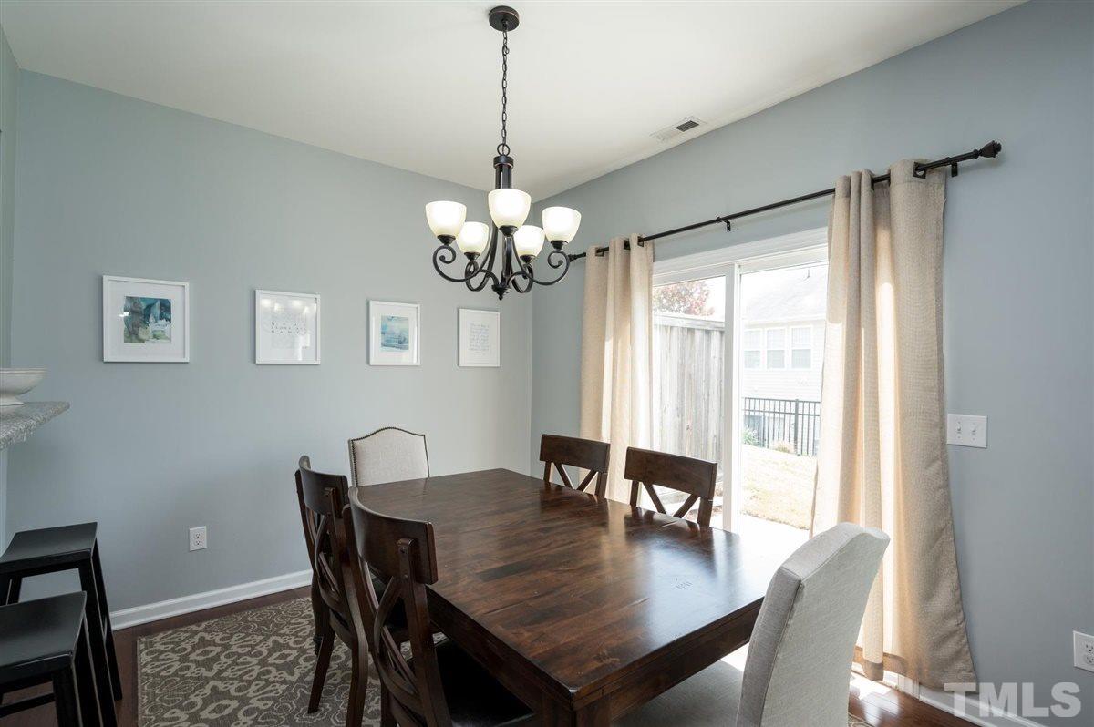 8705 Wild Magnolia Drive Raleigh, NC 27617 - Photo 5 of 15 a view of a dining room with furniture window and wooden floor