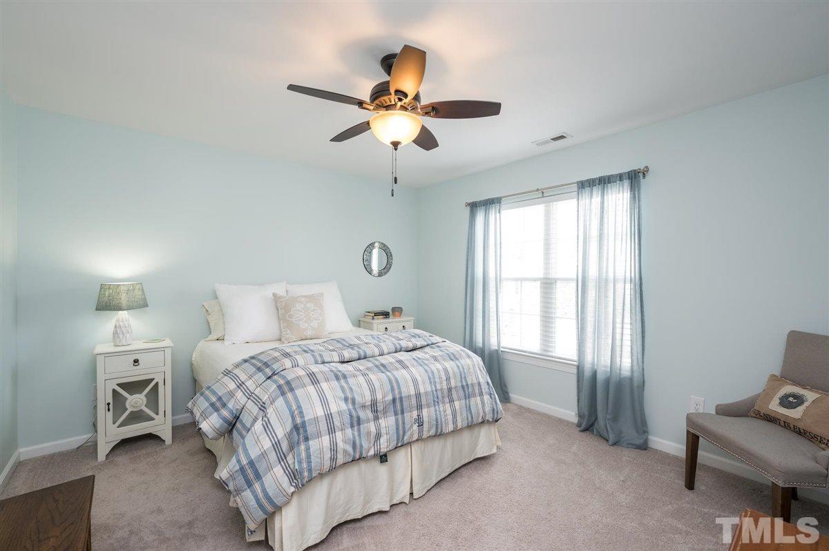 8705 Wild Magnolia Drive Raleigh, NC 27617 - Photo 10 of 15 a bedroom with a bed furniture and a window