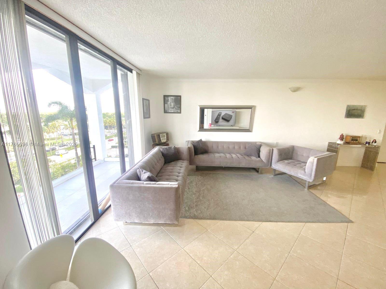 9801 Collins Avenue, Unit 8M Bal Harbour, FL 33154 - Photo 14 of 29 a living room with furniture and a large window