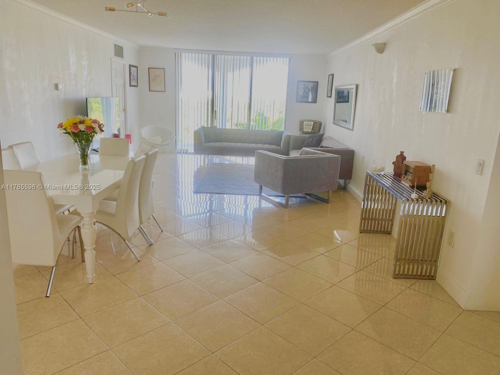 9801 Collins Avenue, Unit 8M Bal Harbour, FL 33154 - Photo 2 of 29 a living room with furniture and a table