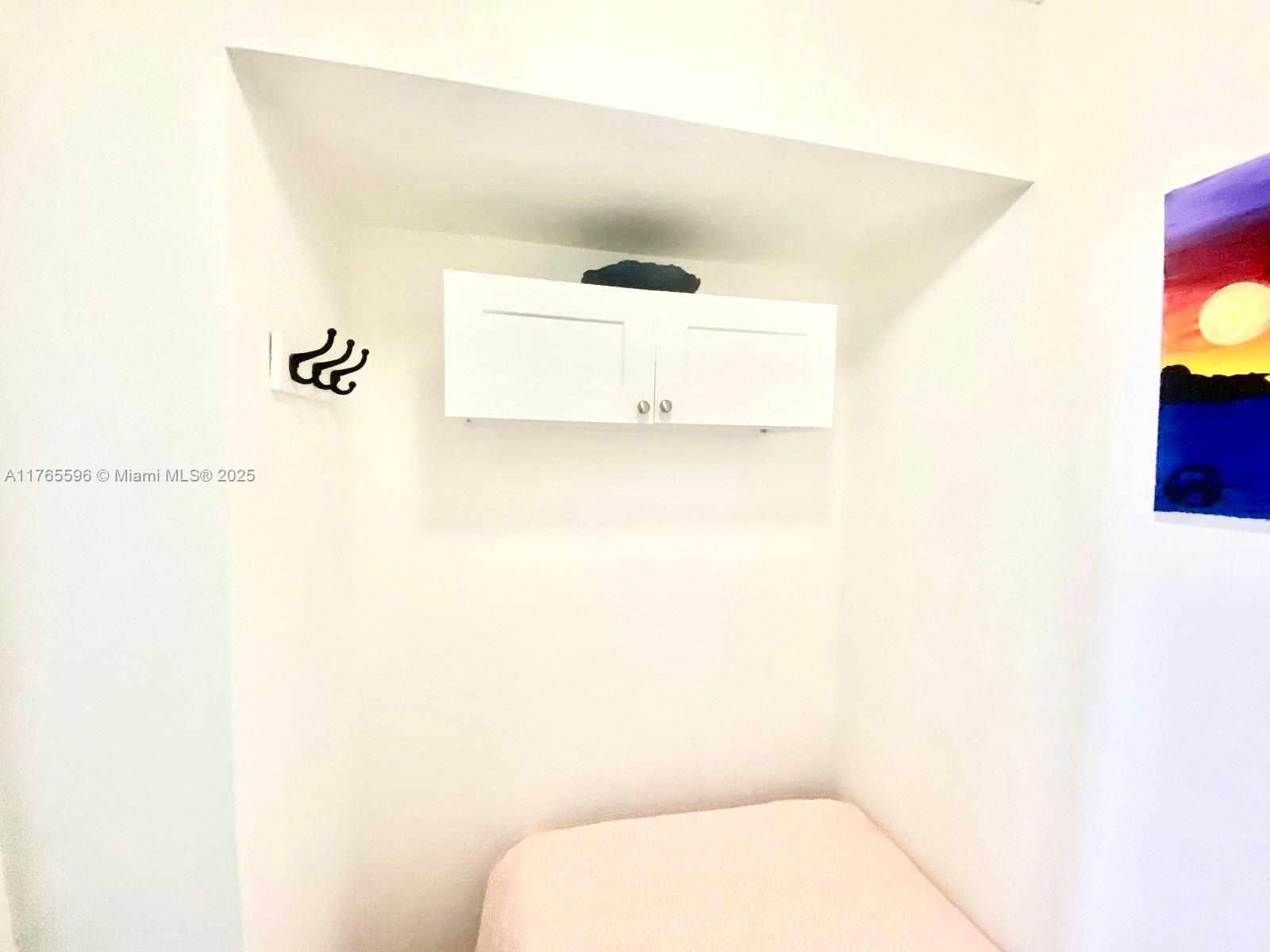 9801 Collins Avenue, Unit 8M Bal Harbour, FL 33154 - Photo 21 of 29 a bathroom with a toilet and a picture