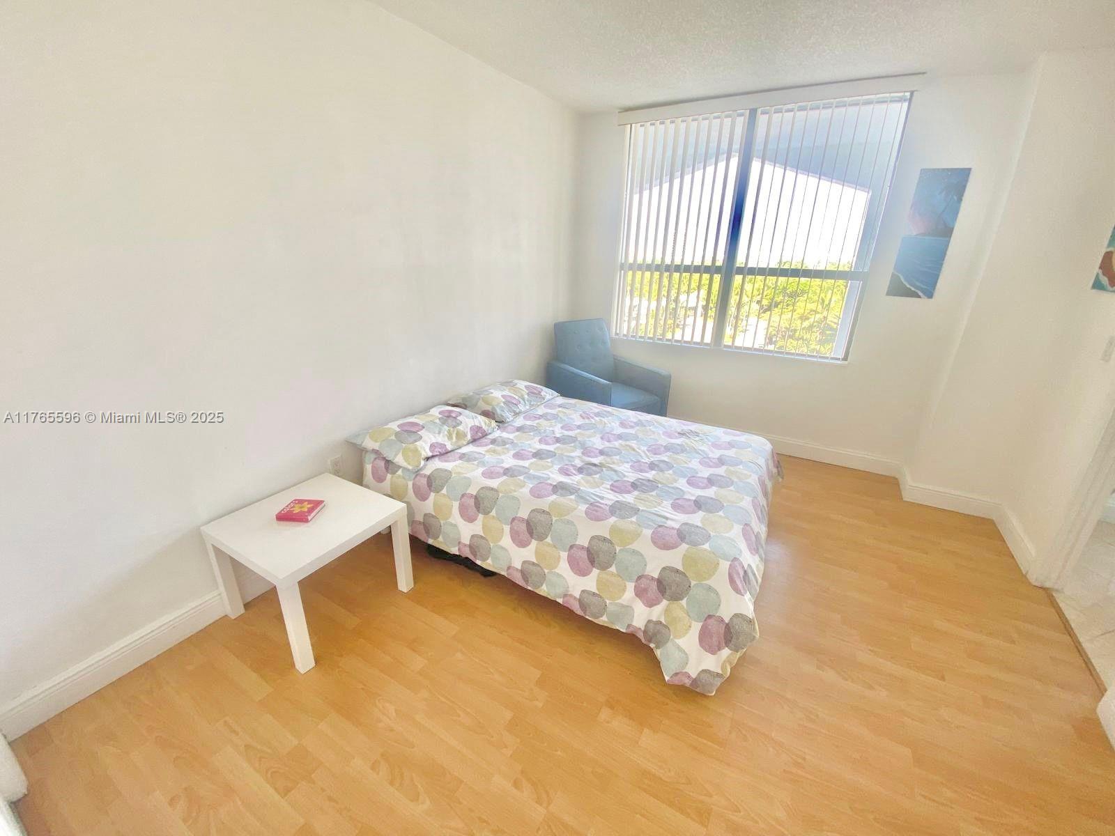 9801 Collins Avenue, Unit 8M Bal Harbour, FL 33154 - Photo 7 of 29 a bedroom with a bed and a window