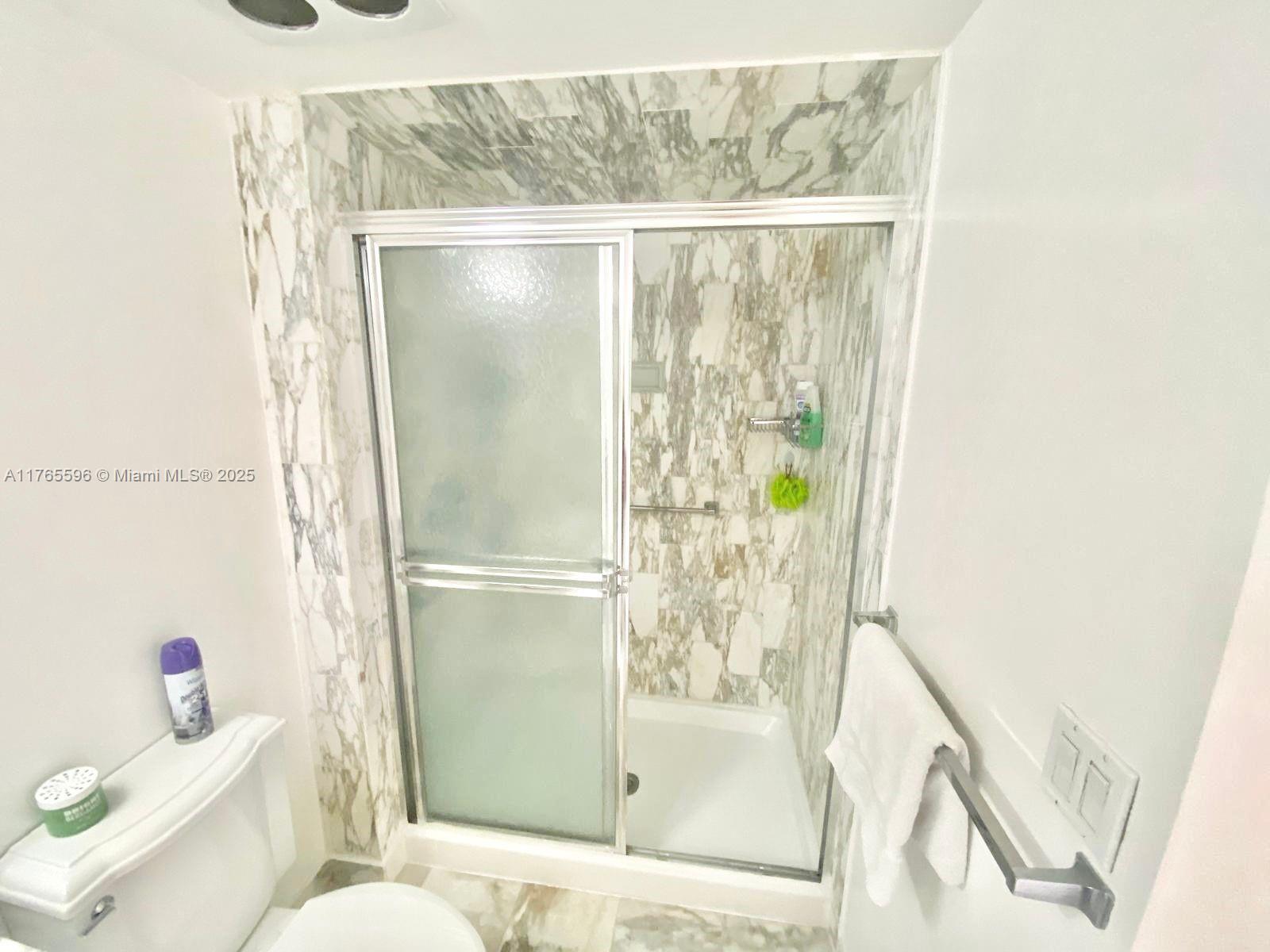 9801 Collins Avenue, Unit 8M Bal Harbour, FL 33154 - Photo 9 of 29 a bathroom with a shower and a toilet