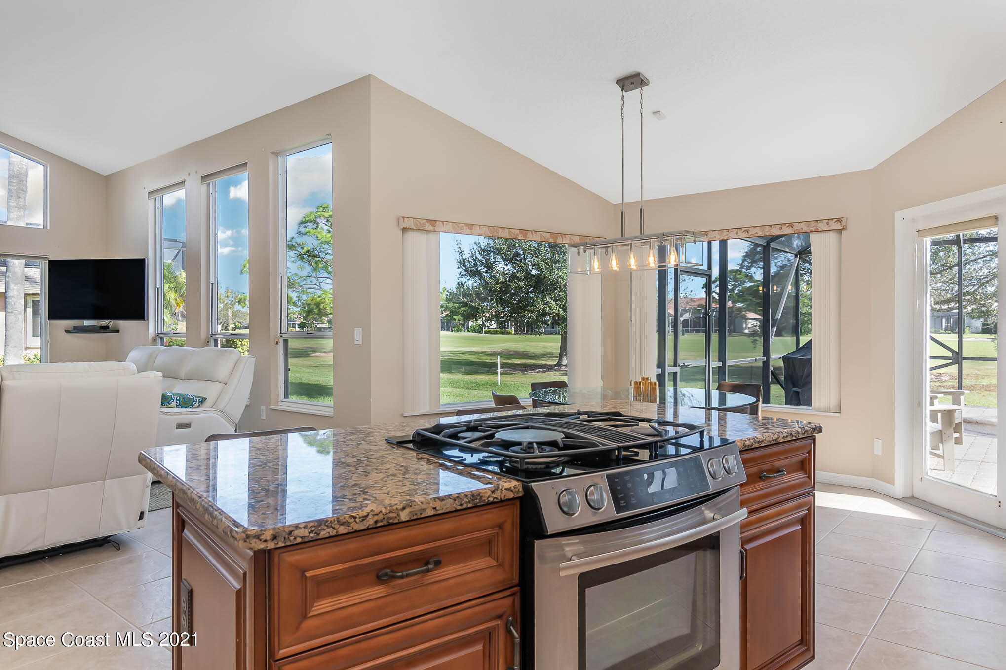 689 Spring Lake Drive Melbourne, FL 32940 - Photo 15 of 49 a kitchen with a stove and a view of living room