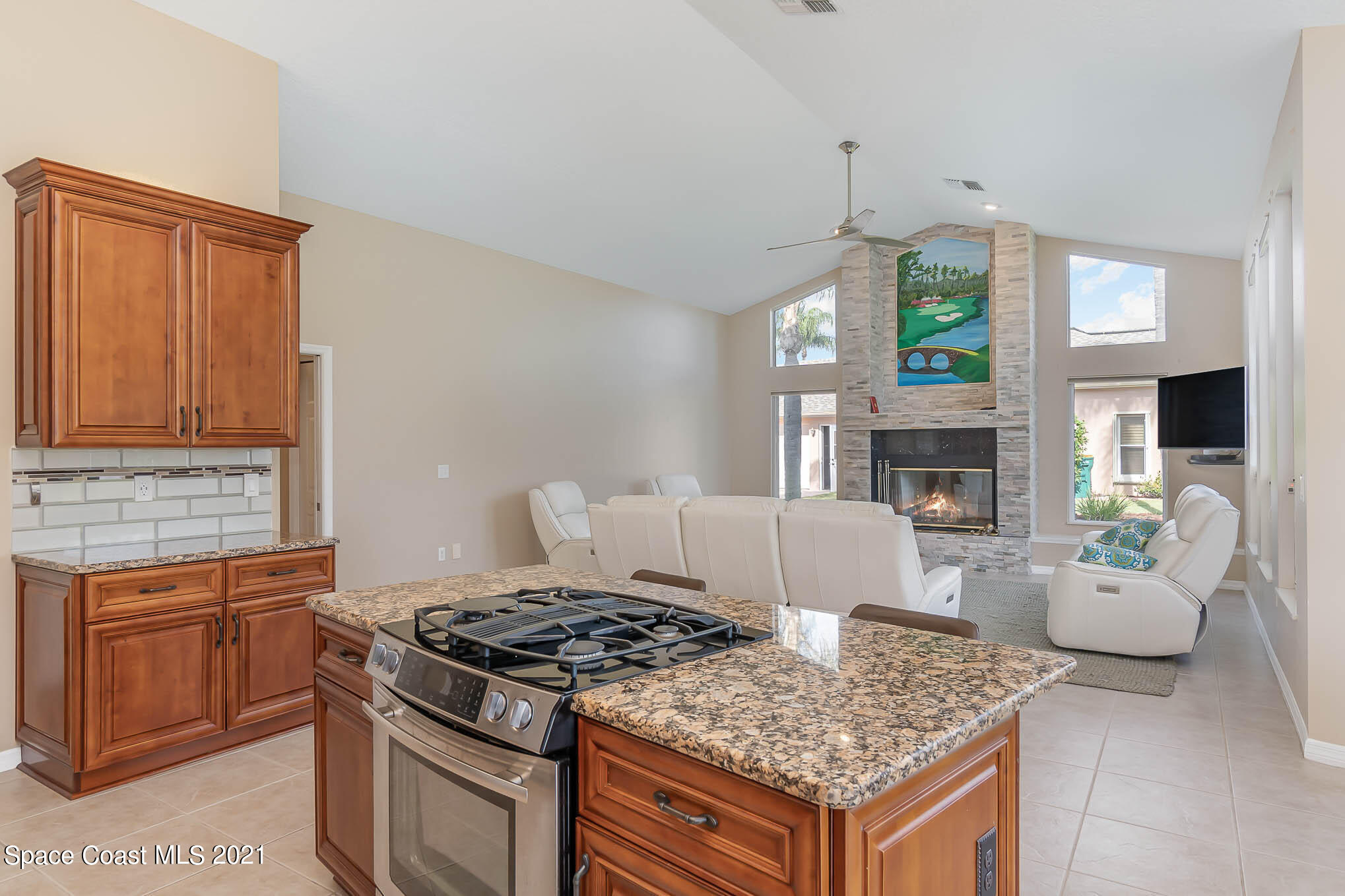 689 Spring Lake Drive Melbourne, FL 32940 - Photo 16 of 49 a kitchen with a stove cabinets and window