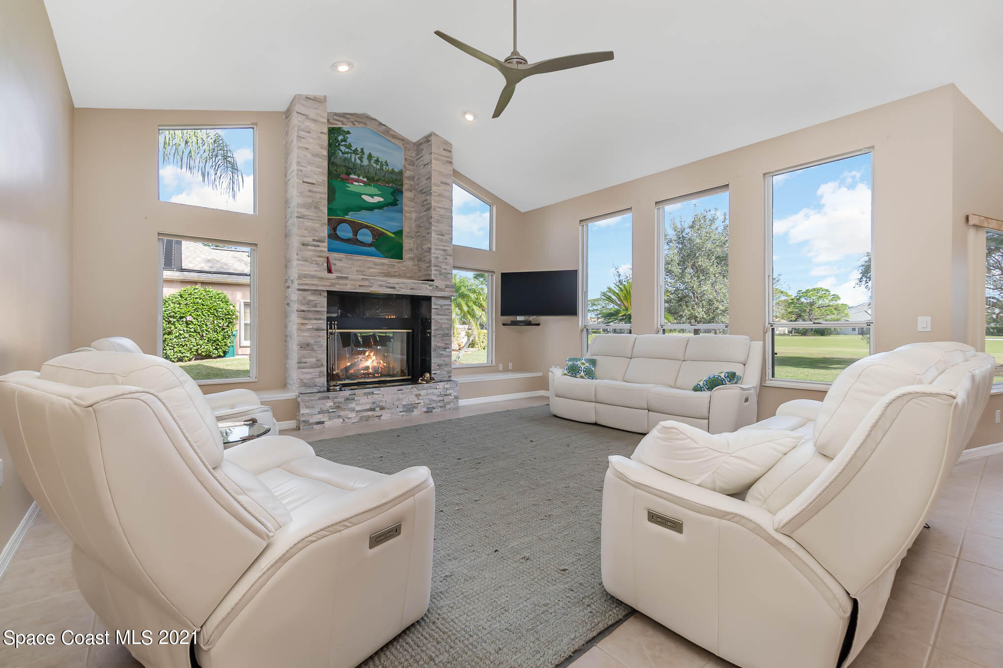 689 Spring Lake Drive Melbourne, FL 32940 - Photo 18 of 49 a living room with furniture fireplace and a large window