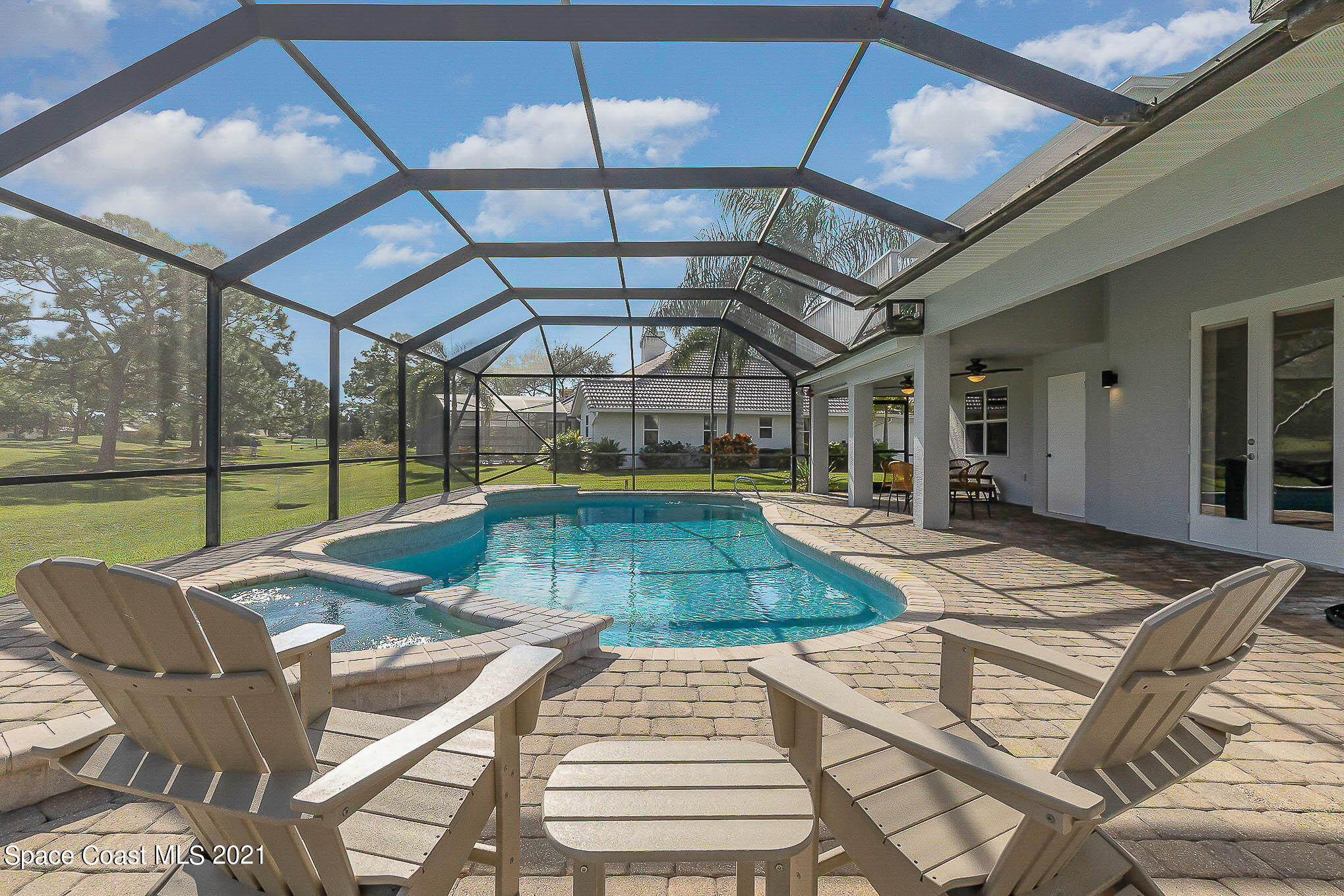 689 Spring Lake Drive Melbourne, FL 32940 - Photo 21 of 49 a view of a swimming pool with a patio