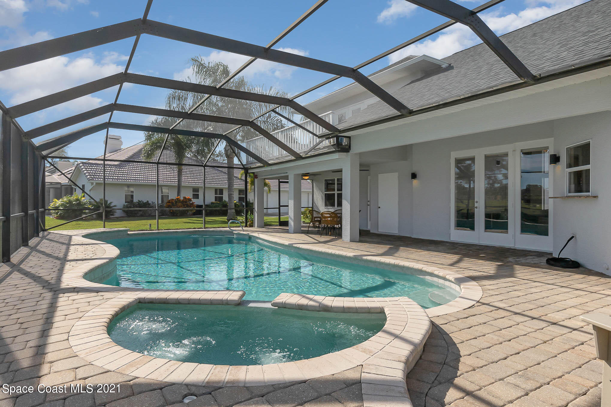 689 Spring Lake Drive Melbourne, FL 32940 - Photo 22 of 49 a view of a swimming pool with a patio