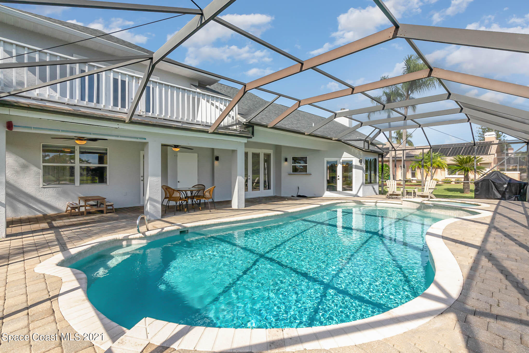 689 Spring Lake Drive Melbourne, FL 32940 - Photo 23 of 49 a view of a house with swimming pool and sitting area