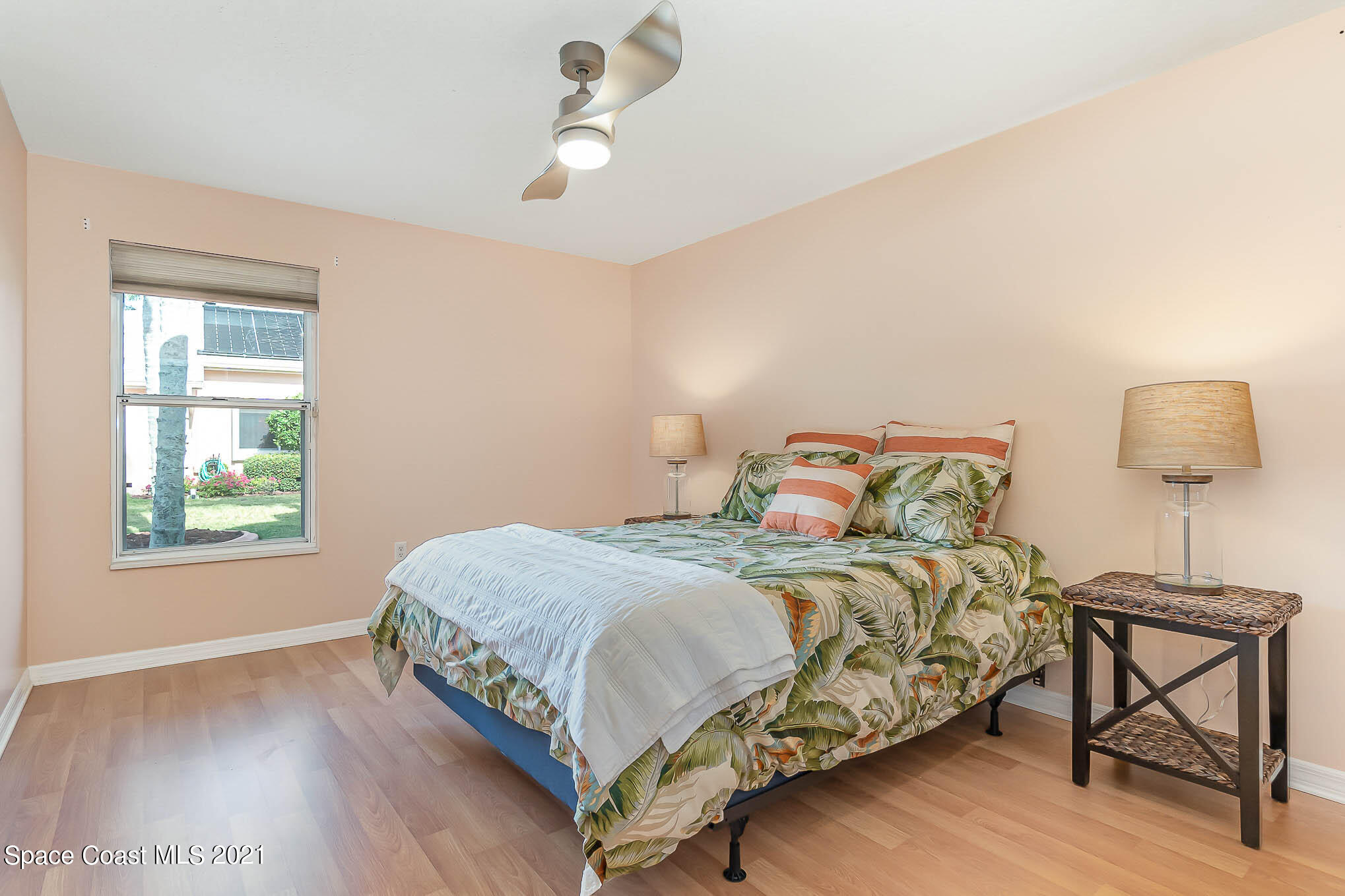 689 Spring Lake Drive Melbourne, FL 32940 - Photo 24 of 49 a bedroom with a bed and a window