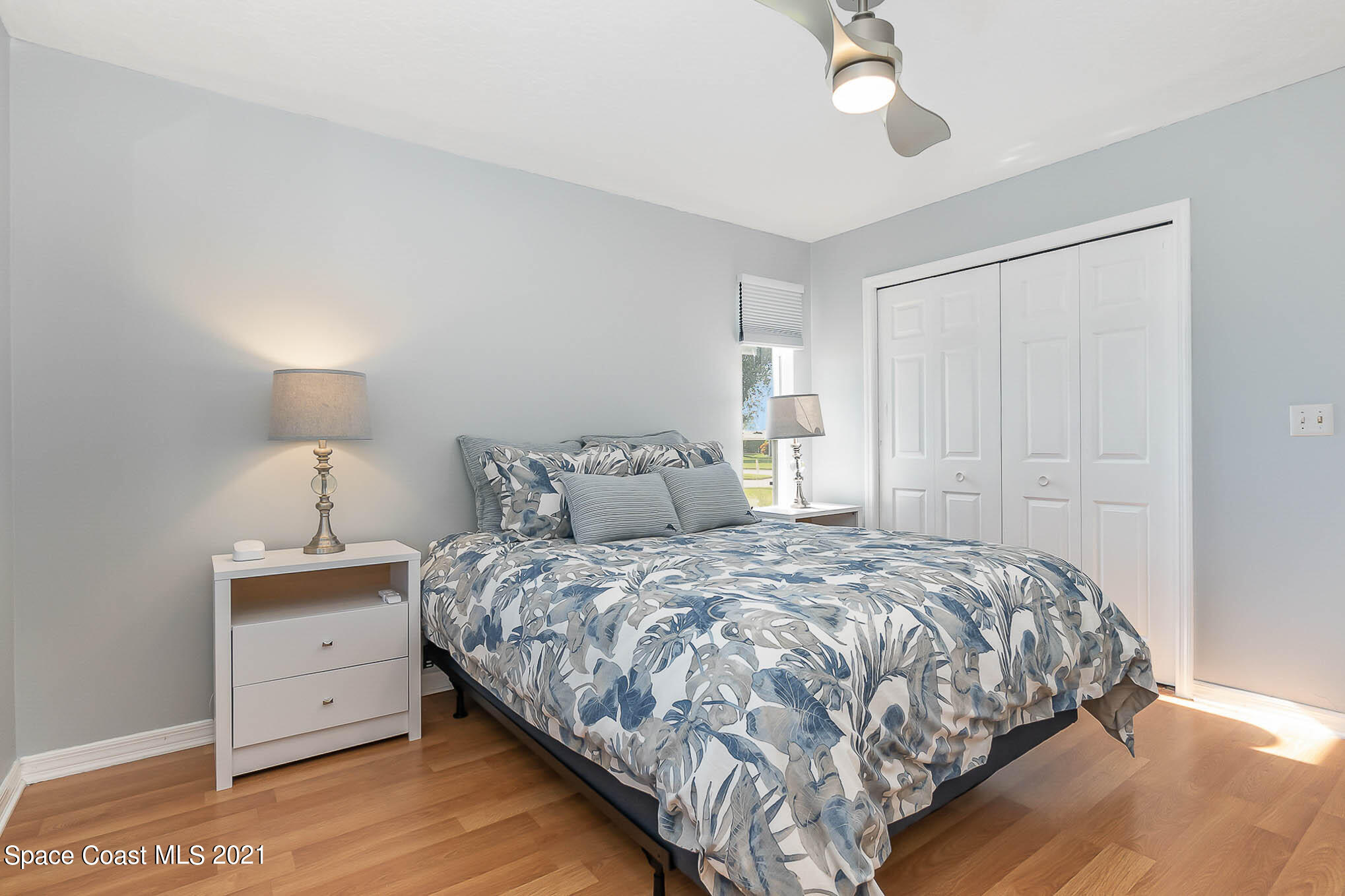 689 Spring Lake Drive Melbourne, FL 32940 - Photo 28 of 49 a bedroom with a bed and a night stand