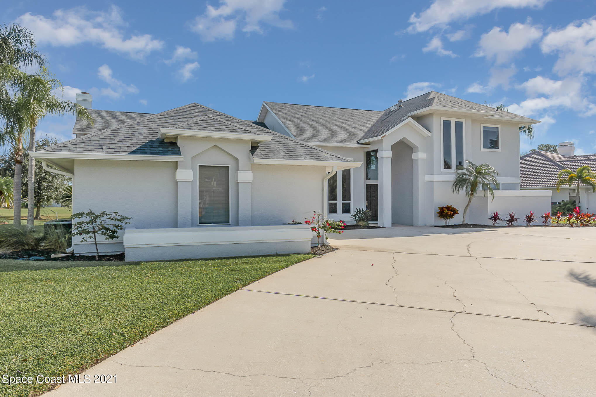 689 Spring Lake Drive Melbourne, FL 32940 - Photo 3 of 49 a front view of a house with a garden