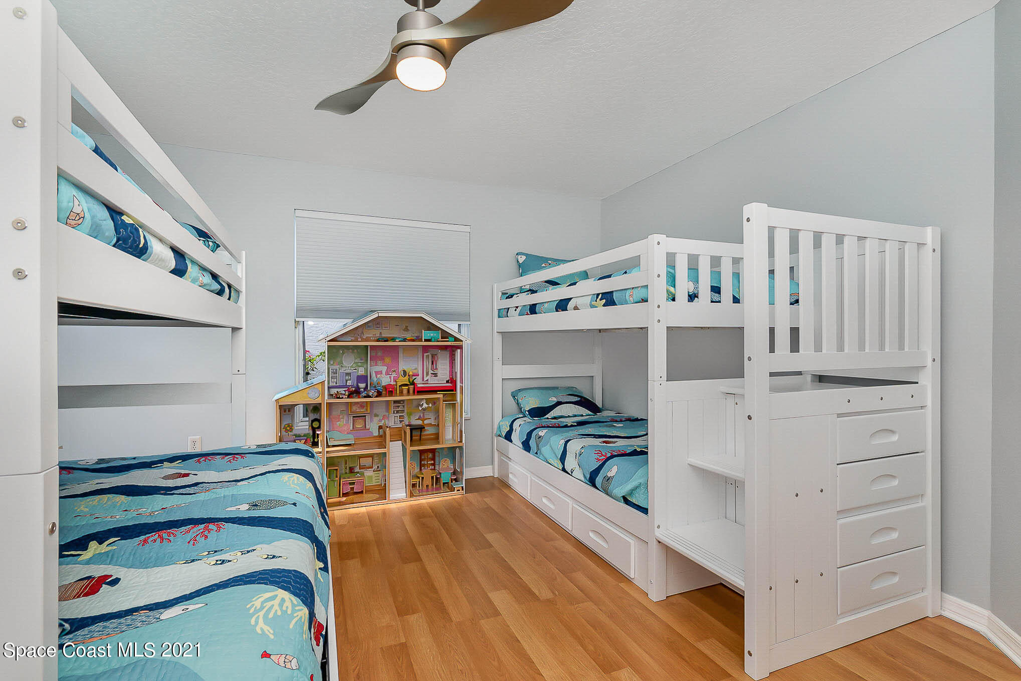 689 Spring Lake Drive Melbourne, FL 32940 - Photo 33 of 49 a bedroom with a bed and wooden floor