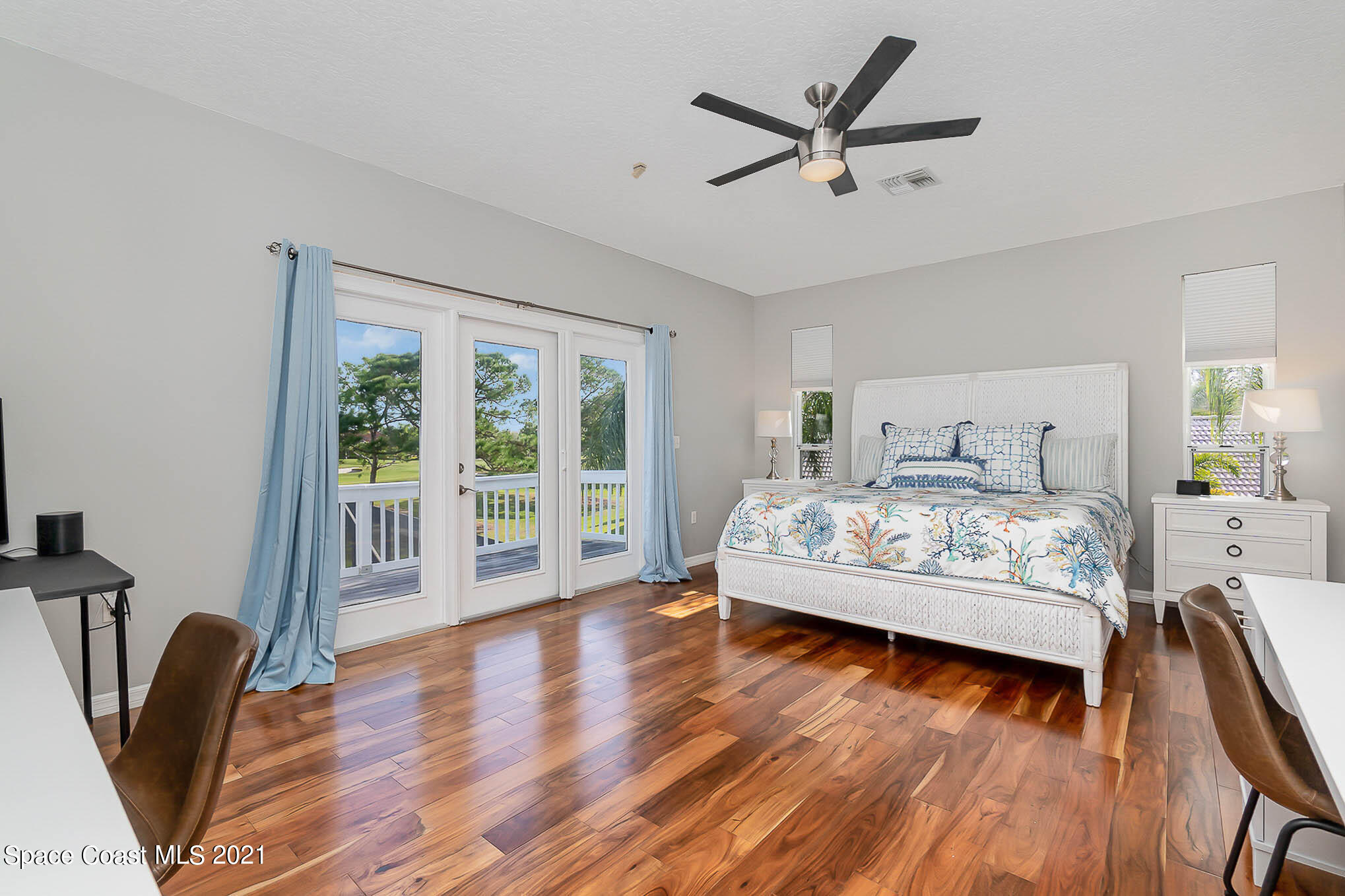 689 Spring Lake Drive Melbourne, FL 32940 - Photo 36 of 49 a bedroom with a large bed and a large window