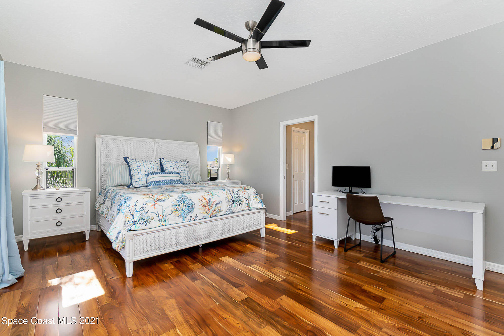 689 Spring Lake Drive Melbourne, FL 32940 - Photo 37 of 49 a bedroom with a bed and a chair