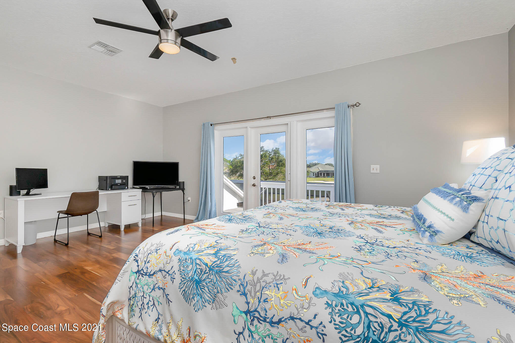 689 Spring Lake Drive Melbourne, FL 32940 - Photo 38 of 49 a bedroom with a bed and a flat screen tv