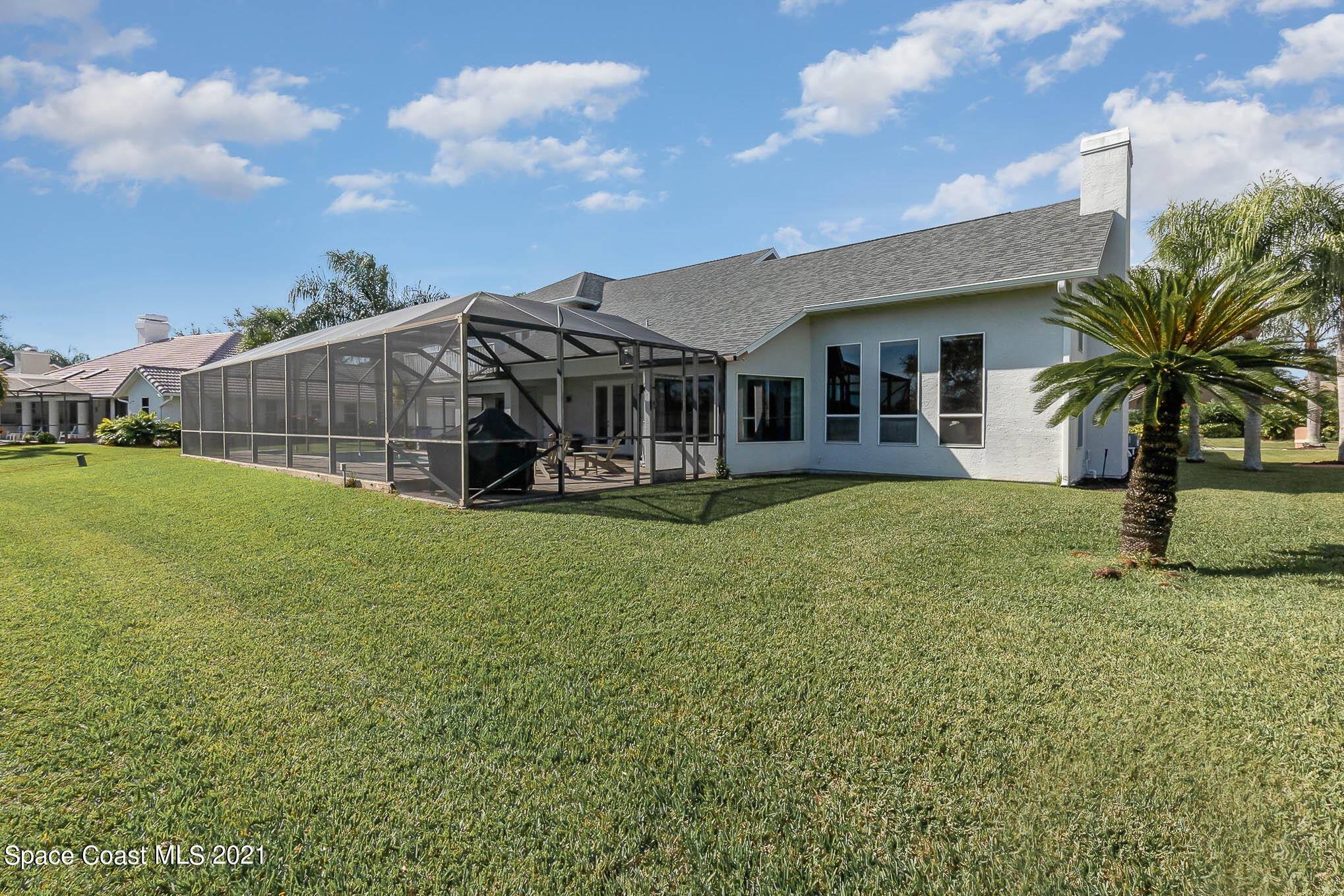 689 Spring Lake Drive Melbourne, FL 32940 - Photo 46 of 49 a view of a house with a yard