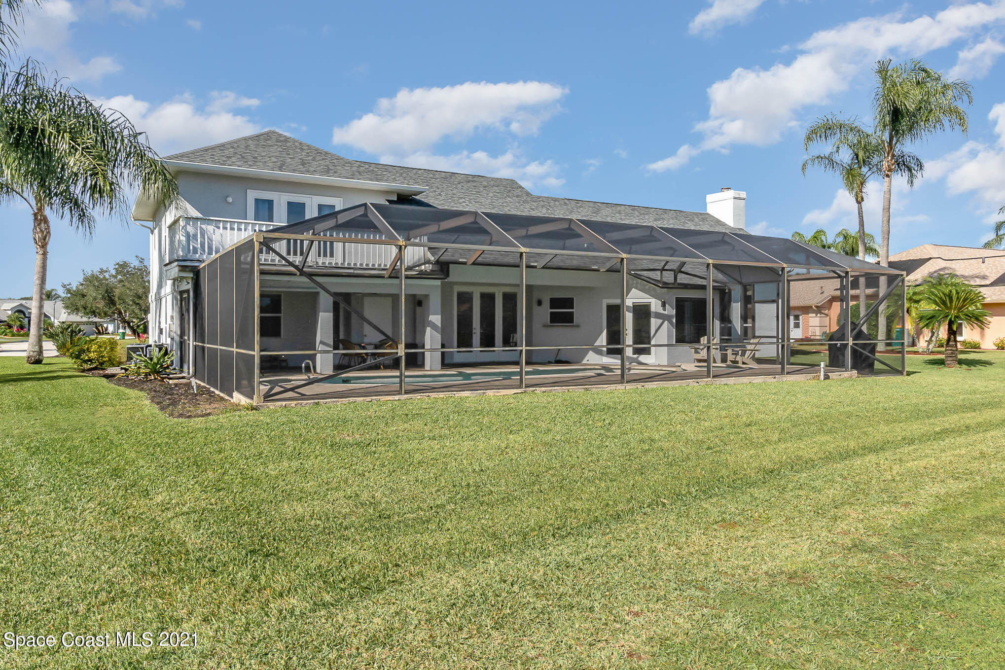 689 Spring Lake Drive Melbourne, FL 32940 - Photo 48 of 49 a front view of a house with a yard table and chairs
