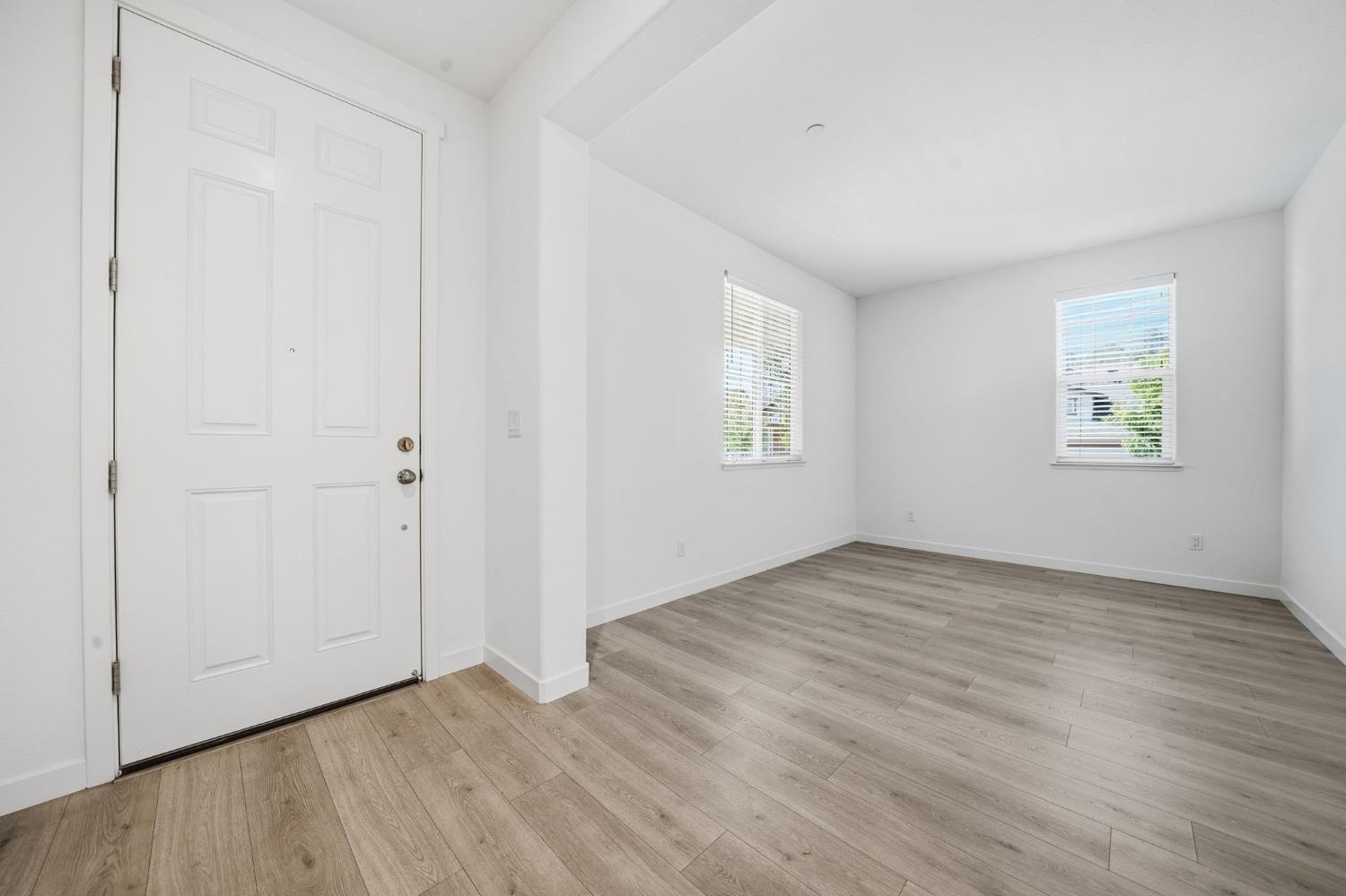 648 Edgewood Loop Angels Camp, CA 95222 - Photo 3 of 58 an empty room with wooden floor and windows