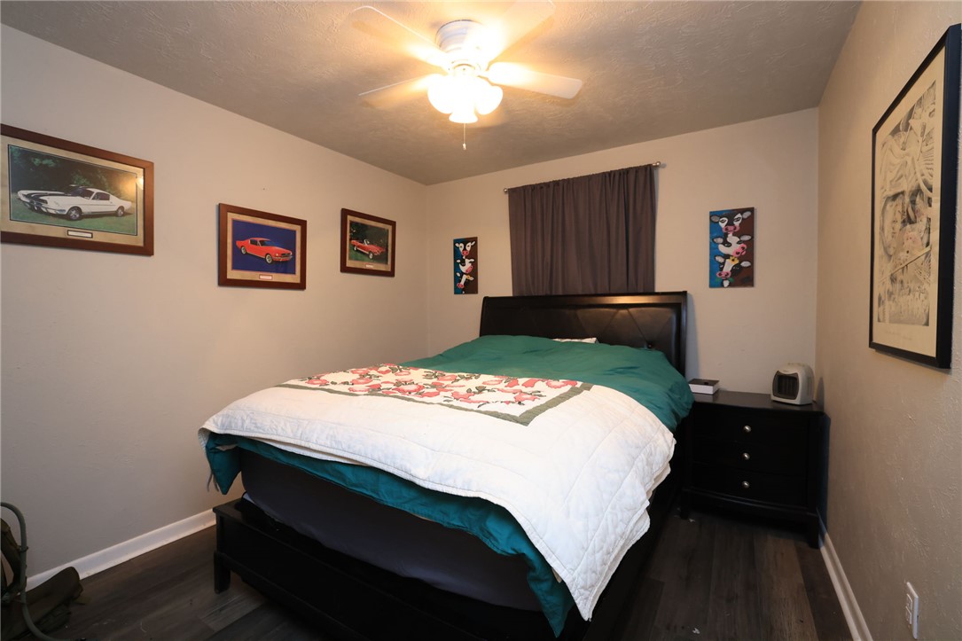 7474 Welch Road Bryan, TX 77808 - Photo 12 of 27 a bedroom with a bed and a desk