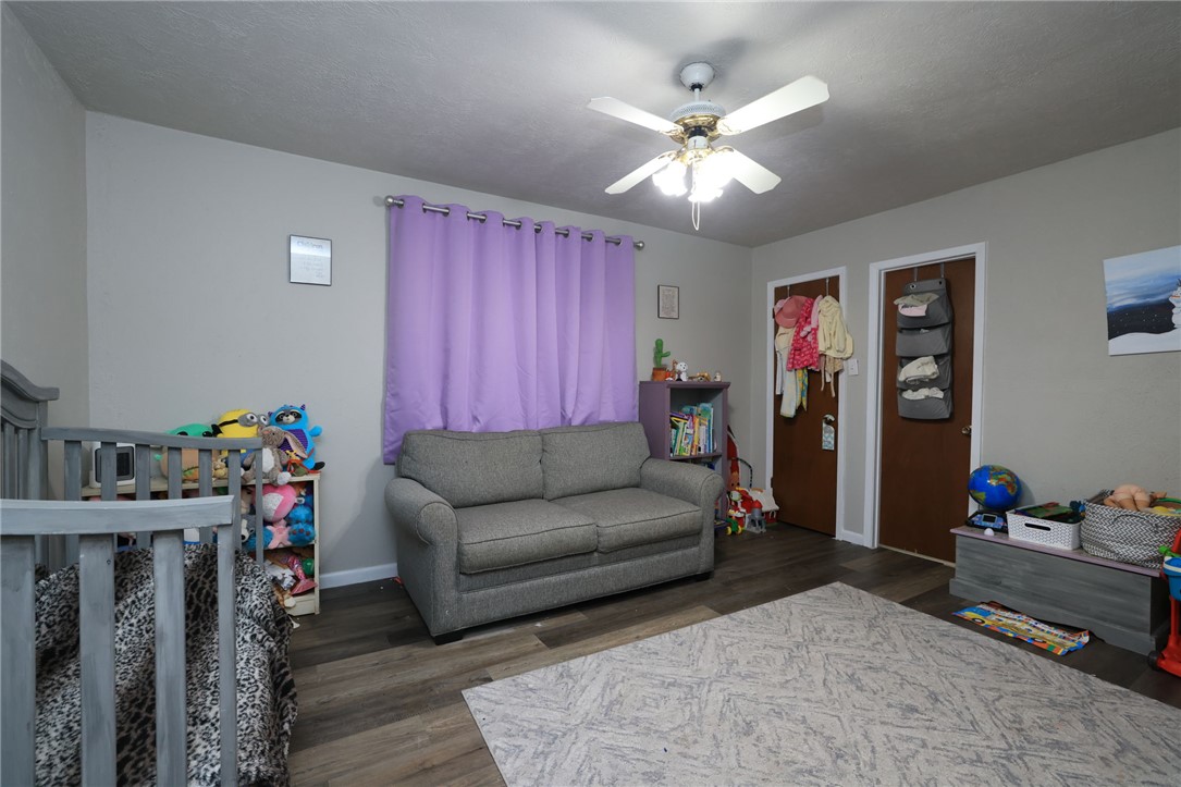 7474 Welch Road Bryan, TX 77808 - Photo 13 of 27 a living room with furniture and wooden floor