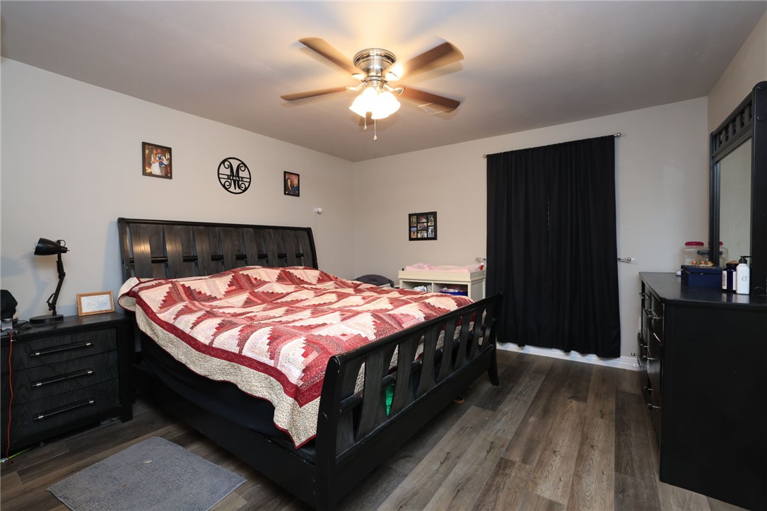 7474 Welch Road Bryan, TX 77808 - Photo 14 of 27 a bed sitting in a bedroom next to a window