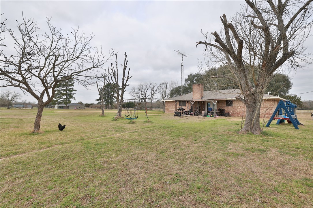 7474 Welch Road Bryan, TX 77808 - Photo 17 of 27 a view of a yard with a tree