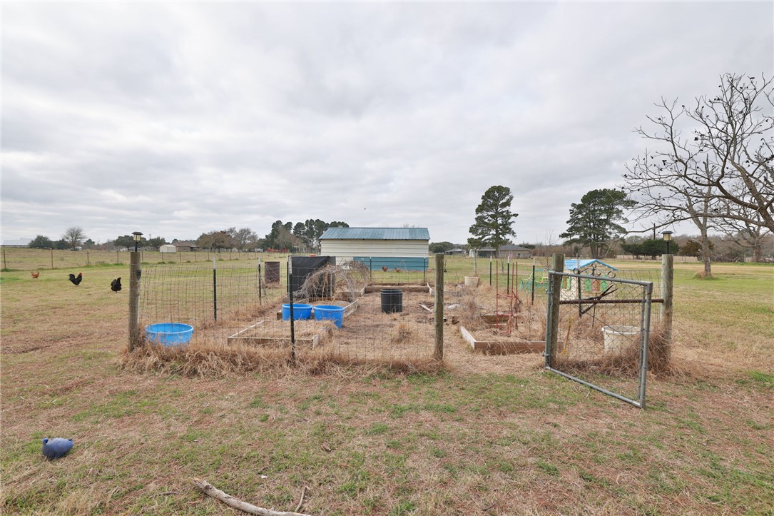 7474 Welch Road Bryan, TX 77808 - Photo 18 of 27 a view of a lake with a yard and large trees
