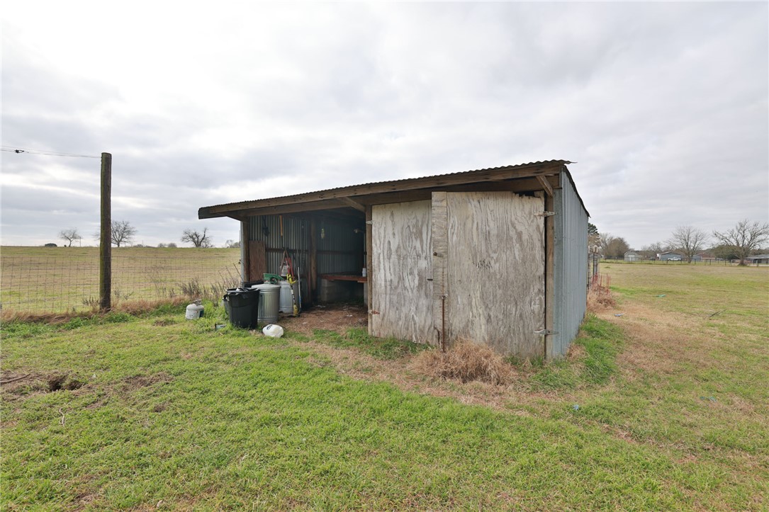 7474 Welch Road Bryan, TX 77808 - Photo 19 of 27 a backyard of a house with yard and seating space