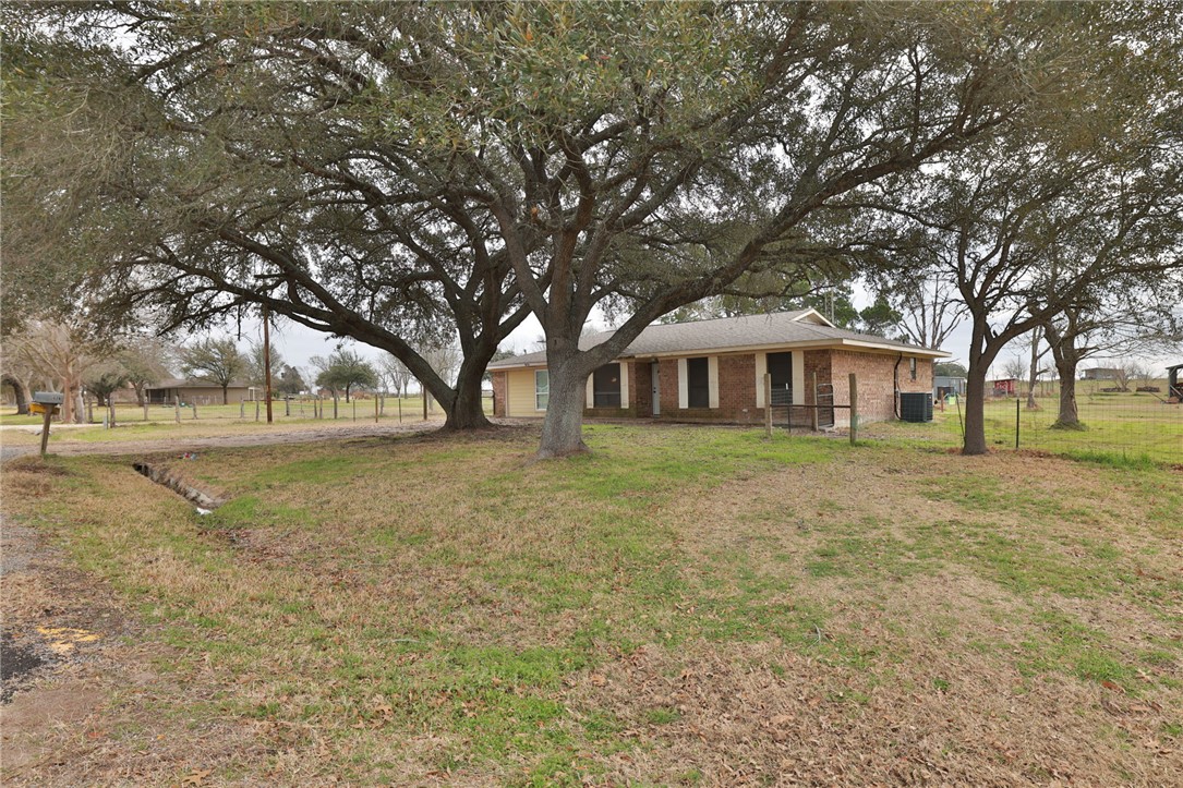 7474 Welch Road Bryan, TX 77808 - Photo 5 of 27 a front view of a house with a yard
