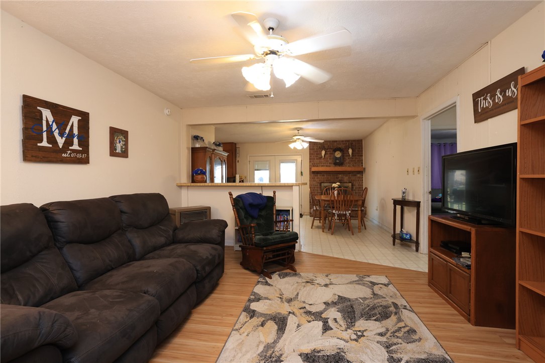 7474 Welch Road Bryan, TX 77808 - Photo 6 of 27 a living room with furniture and a flat screen tv