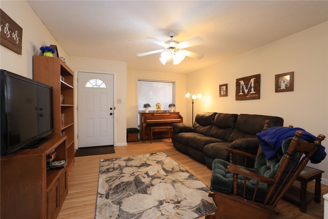 7474 Welch Road Bryan, TX 77808 - Photo 7 of 27 a living room with furniture and a flat screen tv