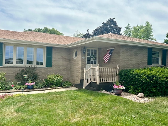 1364 West Tower Road Kankakee, IL 60901 - Photo 2 of 18 a front view of a house with a garden and plants