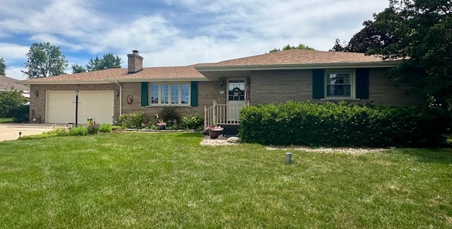 1364 West Tower Road Kankakee, IL 60901 - Photo 3 of 18 a front view of a house with a yard and garage
