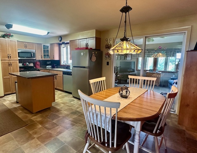 1364 West Tower Road Kankakee, IL 60901 - Photo 9 of 18 a dining room with furniture a chandelier and wooden floor