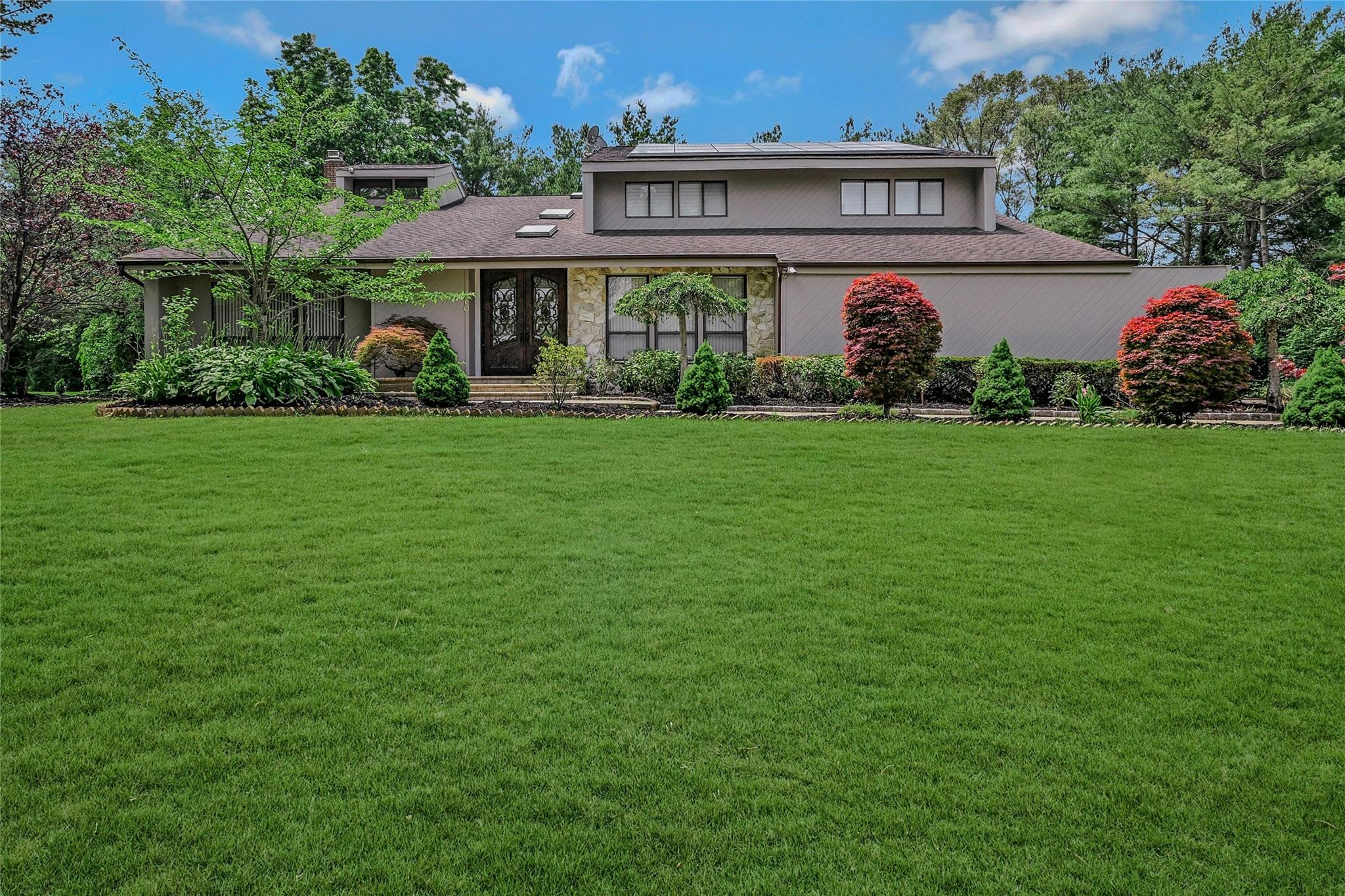 a front view of a house with garden