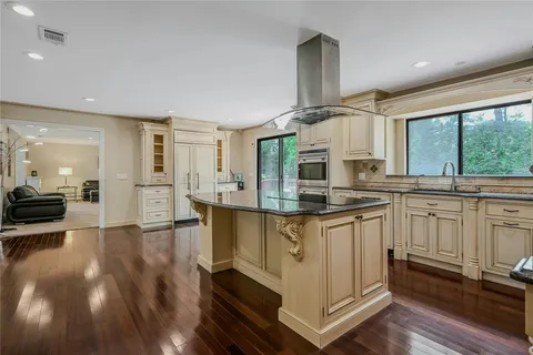 a kitchen with stainless steel appliances granite countertop a stove a sink and a refrigerator