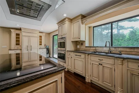 a kitchen with stainless steel appliances a stove sink and microwave