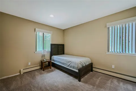 a spacious bedroom with a bed and a window