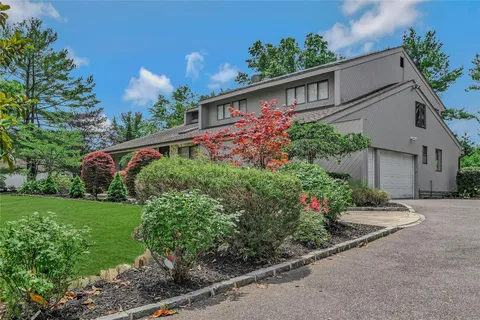a view of a house with a yard and garden