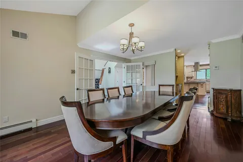 a view of a dining room with furniture wooden floor and chandelier