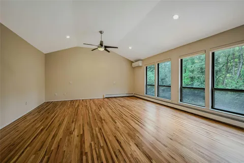a view of room with window and wooden floor