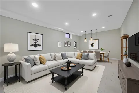 a living room with furniture a rug and a flat screen tv